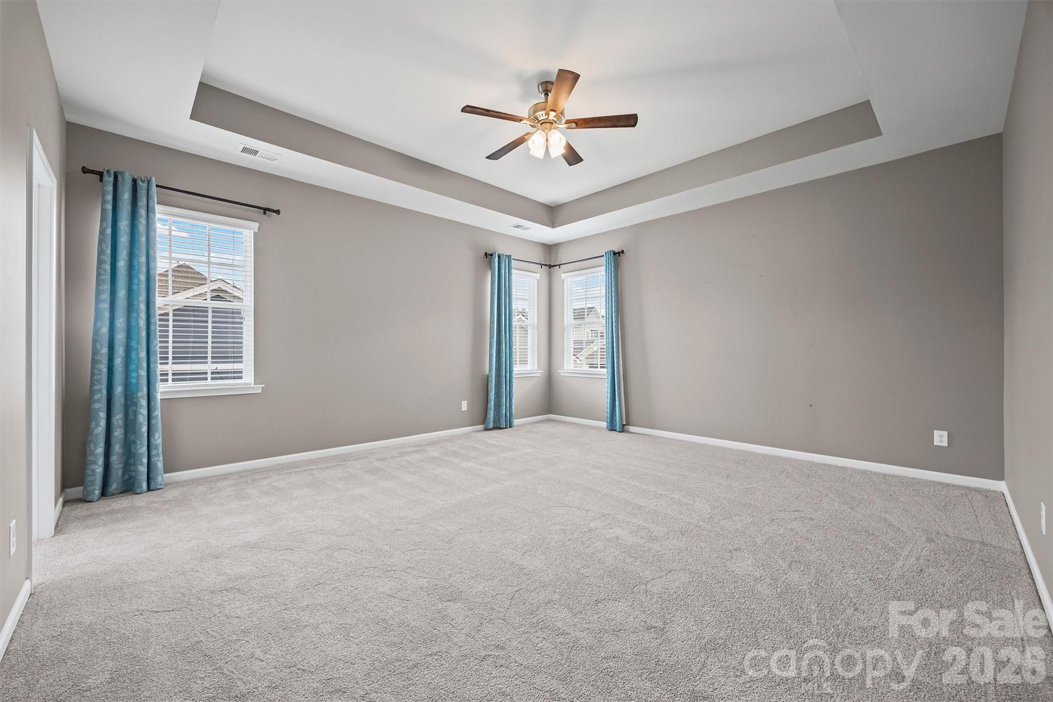 6179 Cloverdale Drive Fort Mill, SC 29708 - Photo 28 of 39 a view of a livingroom with a ceiling fan & windows