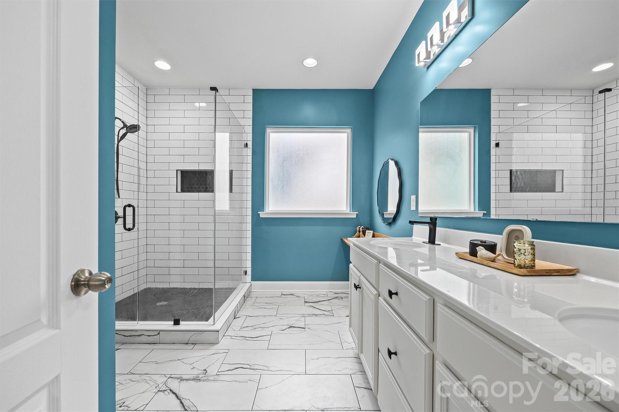 6179 Cloverdale Drive Fort Mill, SC 29708 - Photo 29 of 39 a bathroom with a double vanity sink mirror and shower