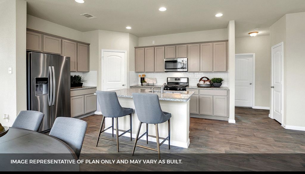 156 Docile Loop San Marcos, TX 78666 - Photo 9 of 40 A well-appointed kitchen features stainless steel appliances, granite countertops, and ample cabinet space.