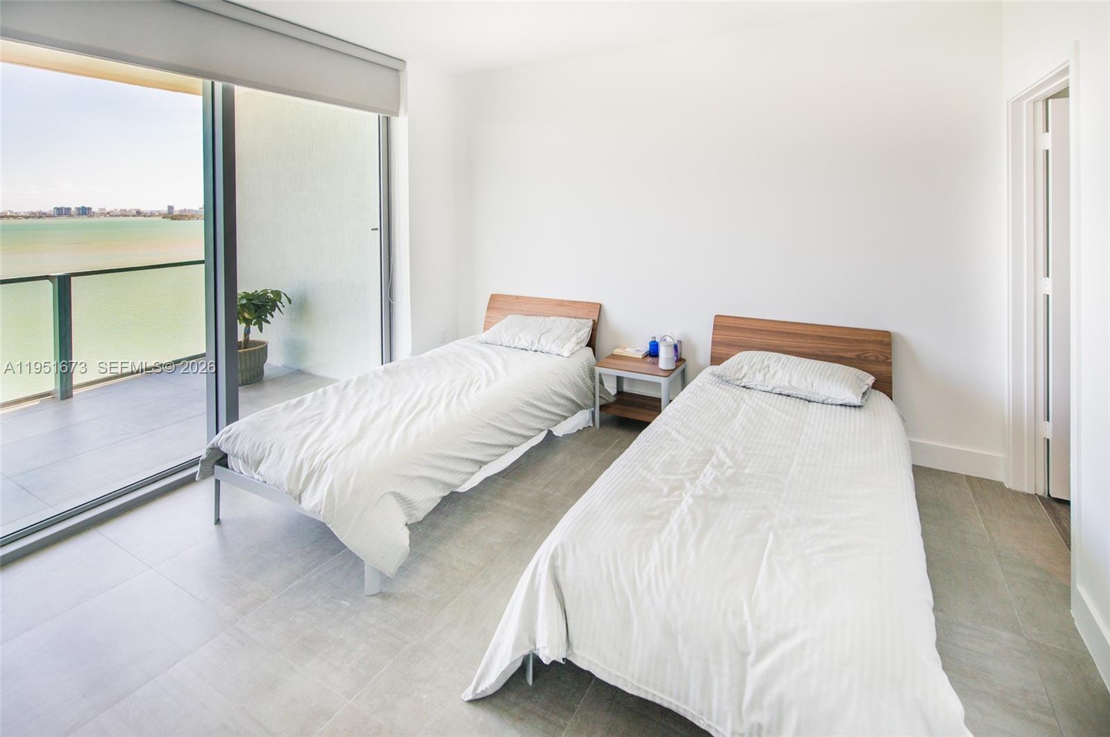 2900 Northeast 7th Avenue, Unit 1903 Miami, FL 33137 - Photo 14 of 43 a bedroom with two beds and a large window