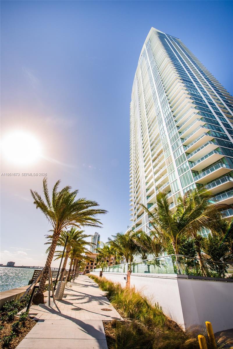 2900 Northeast 7th Avenue, Unit 1903 Miami, FL 33137 - Photo 24 of 43 a view of a tall building with a palm tree in the background