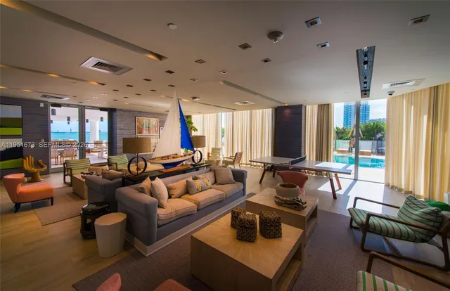 a living room with furniture a large window and a flat screen tv