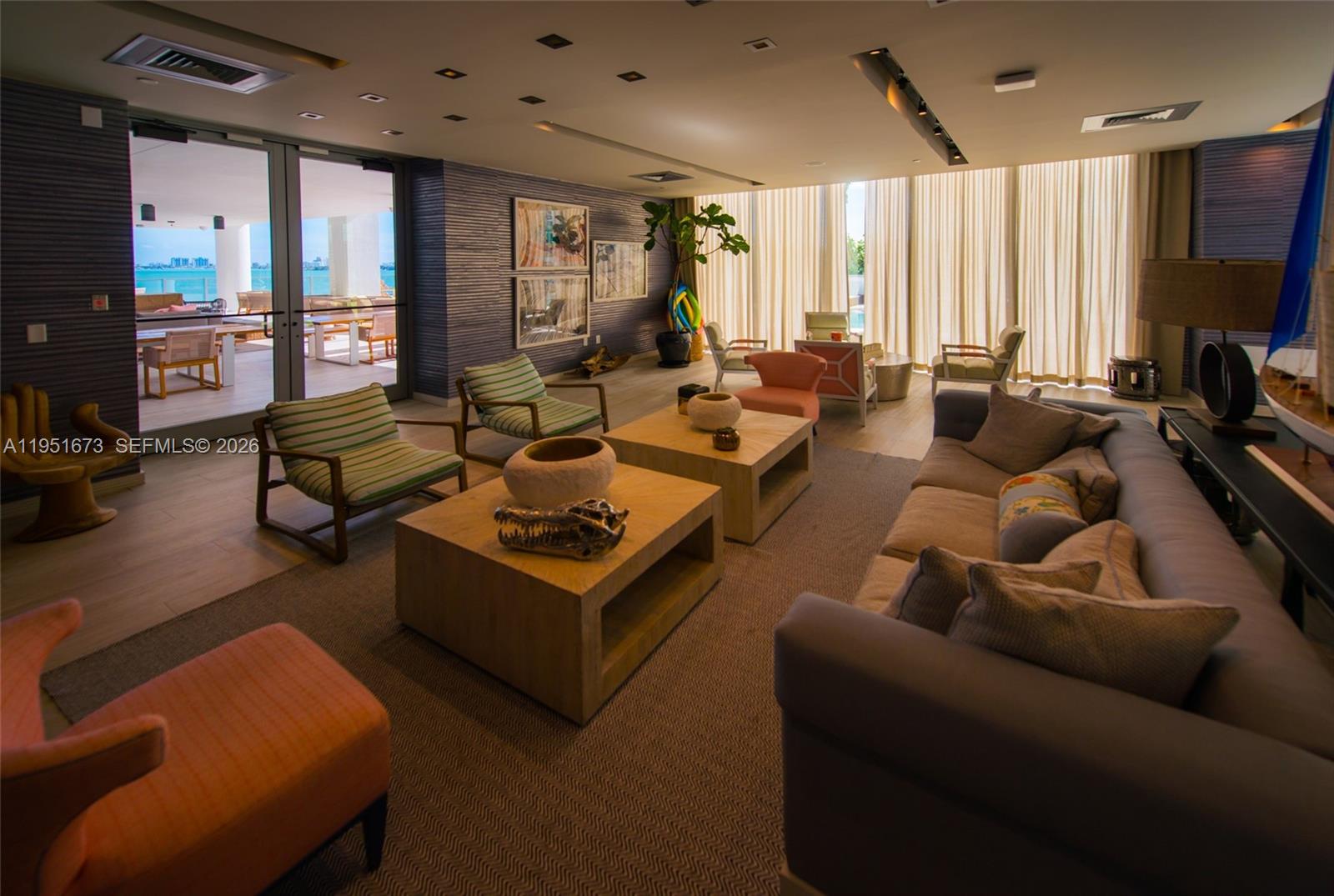 2900 Northeast 7th Avenue, Unit 1903 Miami, FL 33137 - Photo 30 of 43 a living room with furniture a large window and a flat screen tv