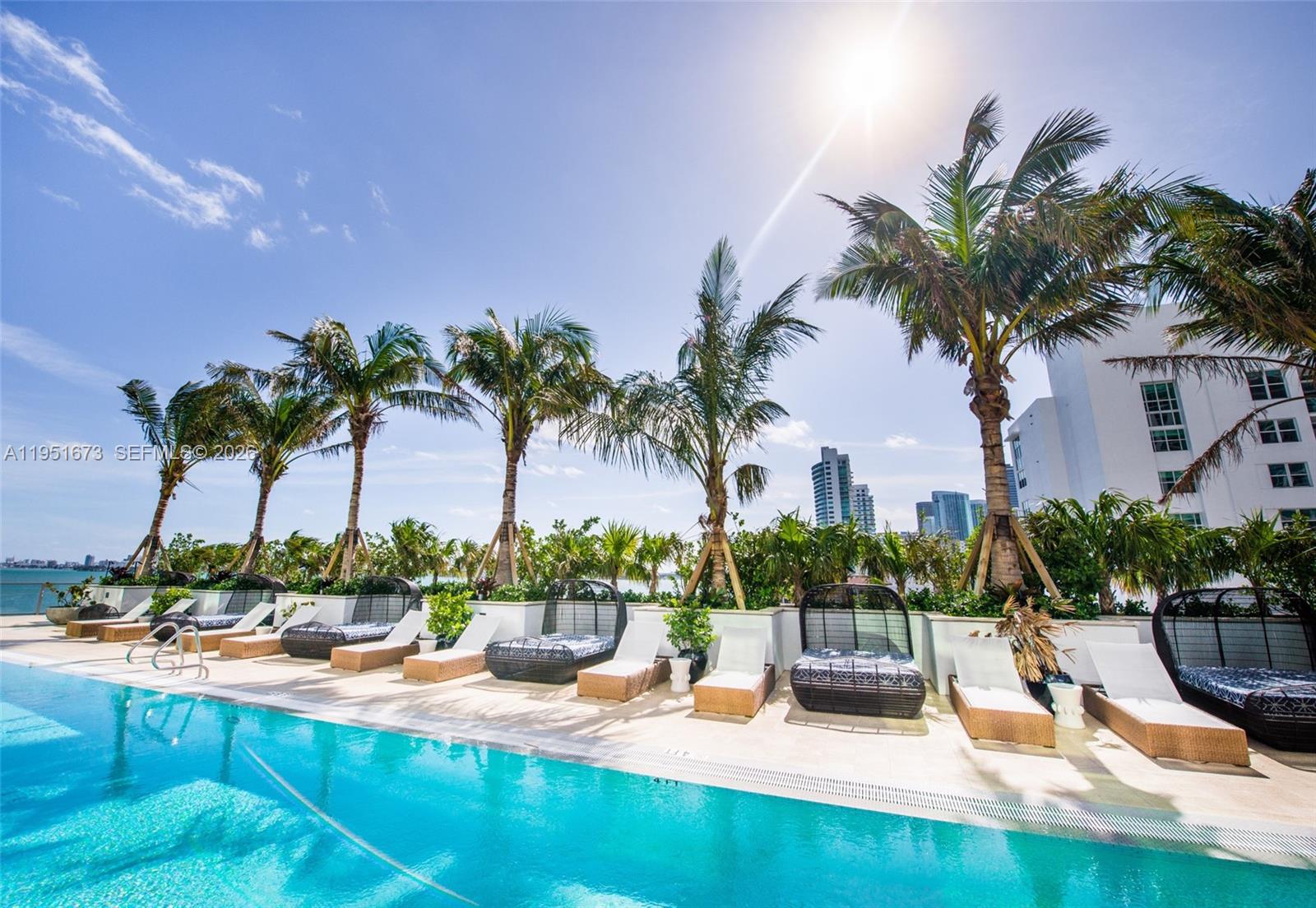 2900 Northeast 7th Avenue, Unit 1903 Miami, FL 33137 - Photo 31 of 43 a view of a swimming pool with a table and chairs