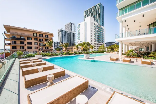 a view of a swimming pool with outdoor seating