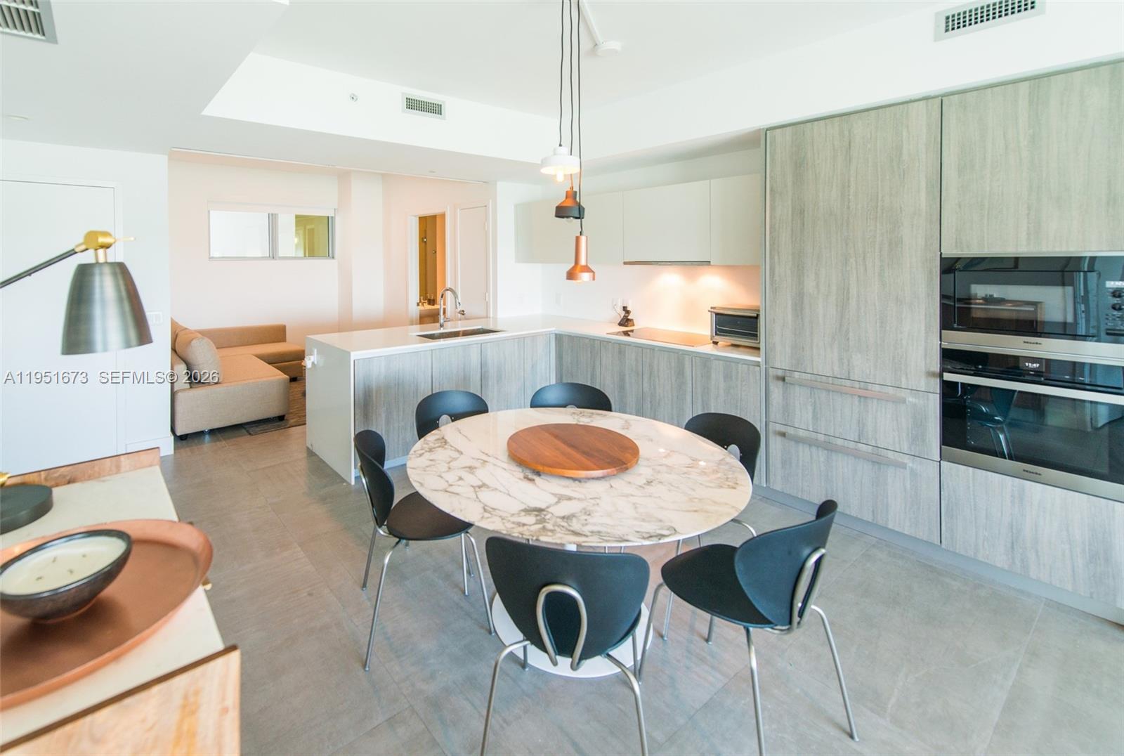 2900 Northeast 7th Avenue, Unit 1903 Miami, FL 33137 - Photo 8 of 43 a view of kitchen and dining area with furniture