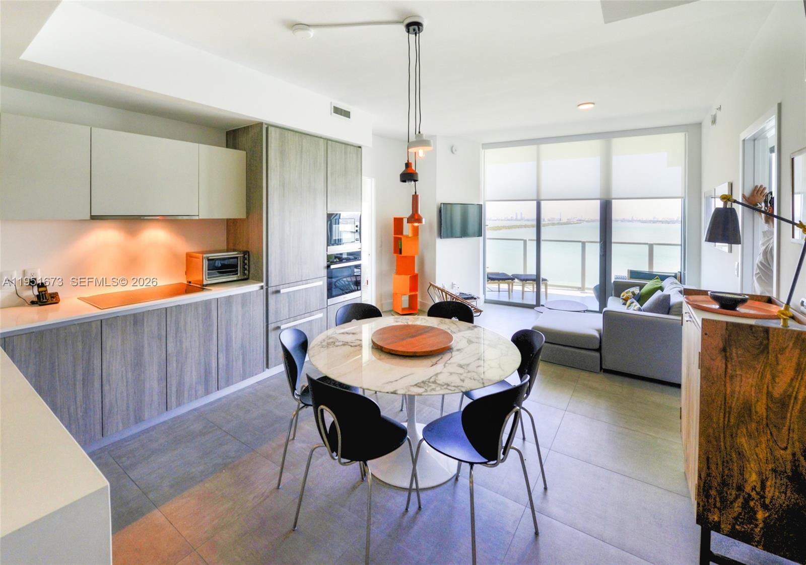 2900 Northeast 7th Avenue, Unit 1903 Miami, FL 33137 - Photo 10 of 43 a dining room with furniture and window