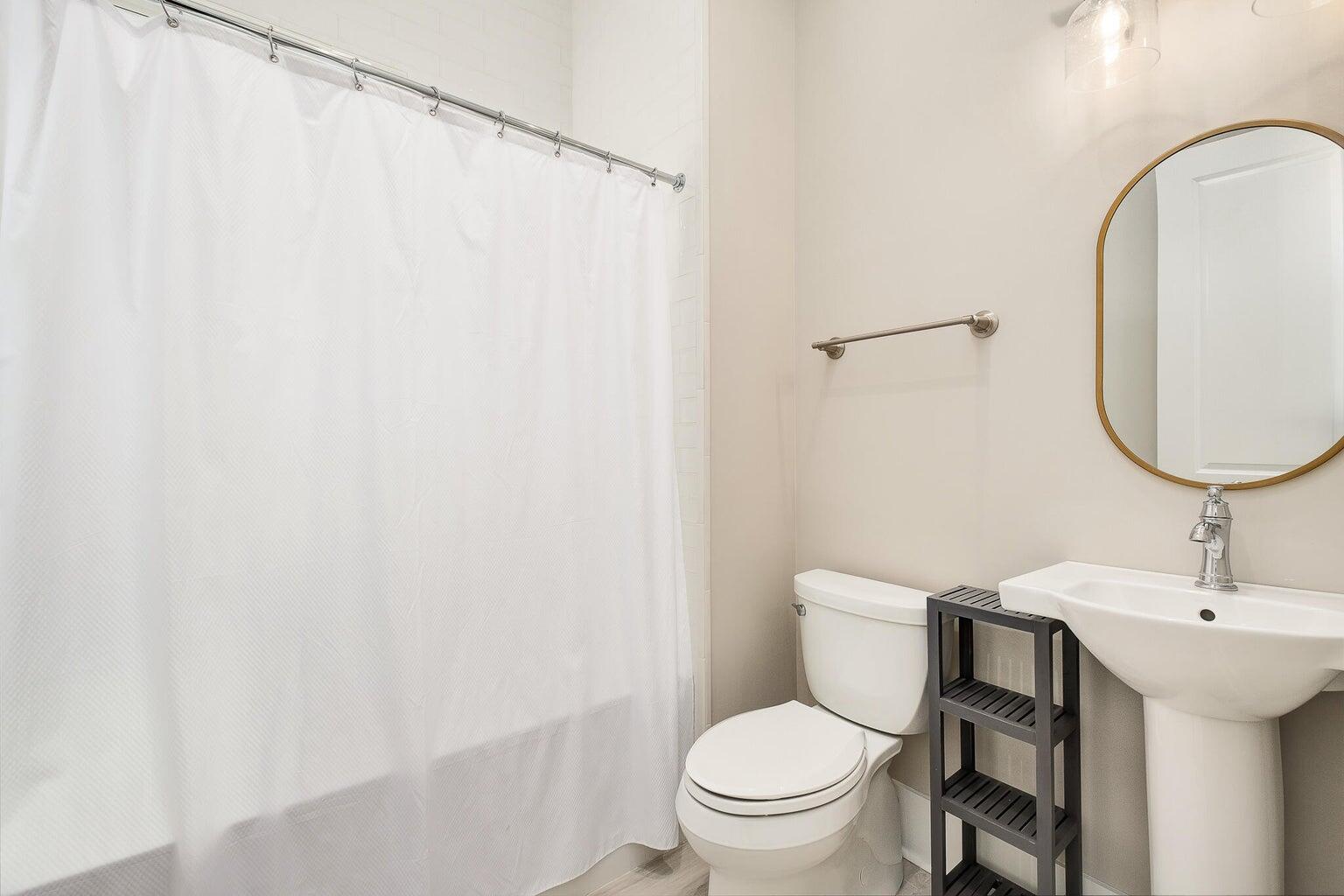 55 Seastone Ct Inlet Beach Inlet Beach, FL 32461 - Photo 54 of 68 a white toilet sitting next to a bathroom sink