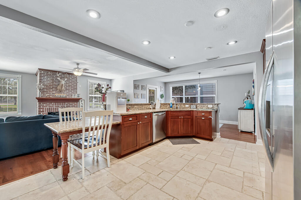 a kitchen with stainless steel appliances a refrigerator and wooden cabinets