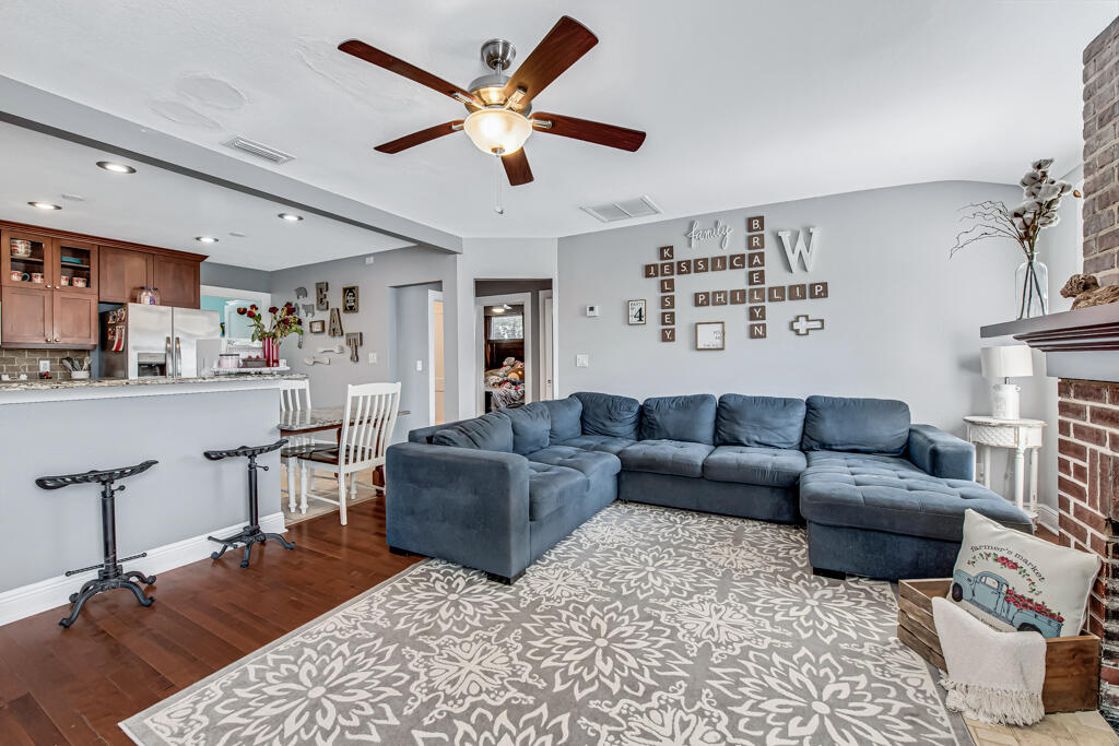 416 Deane Duff Street Clewiston, FL 33440 - Photo 2 of 45 a living room with furniture and a fireplace