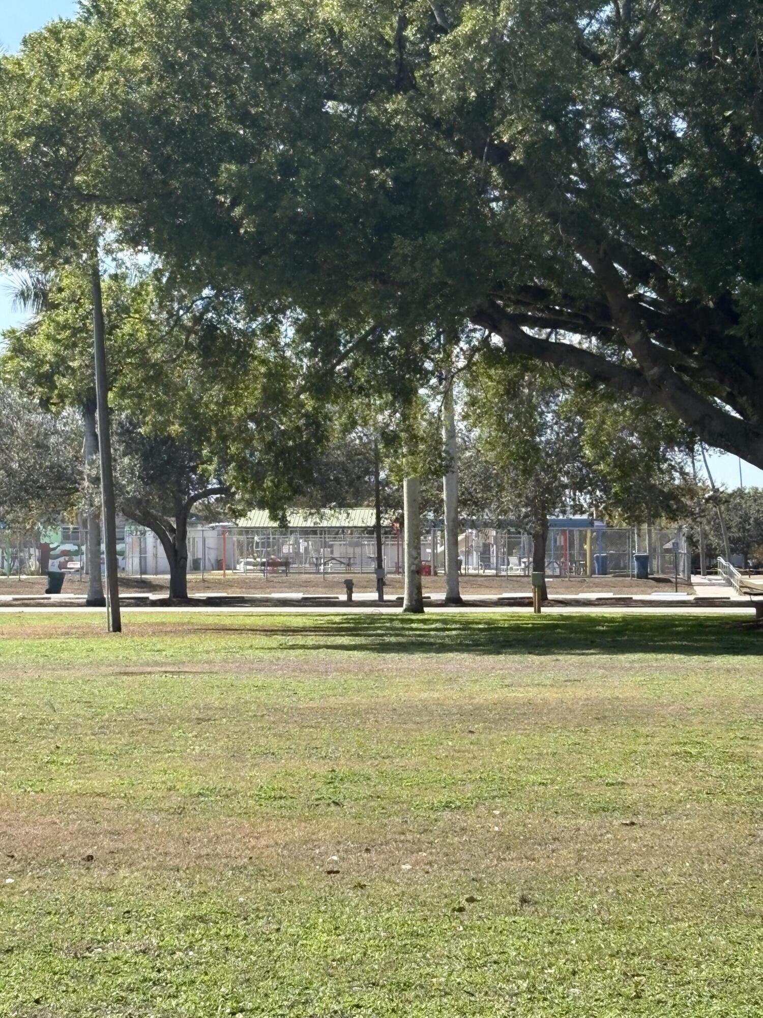 416 Deane Duff Street Clewiston, FL 33440 - Photo 45 of 45 a swimming pool with outdoor seating and yard
