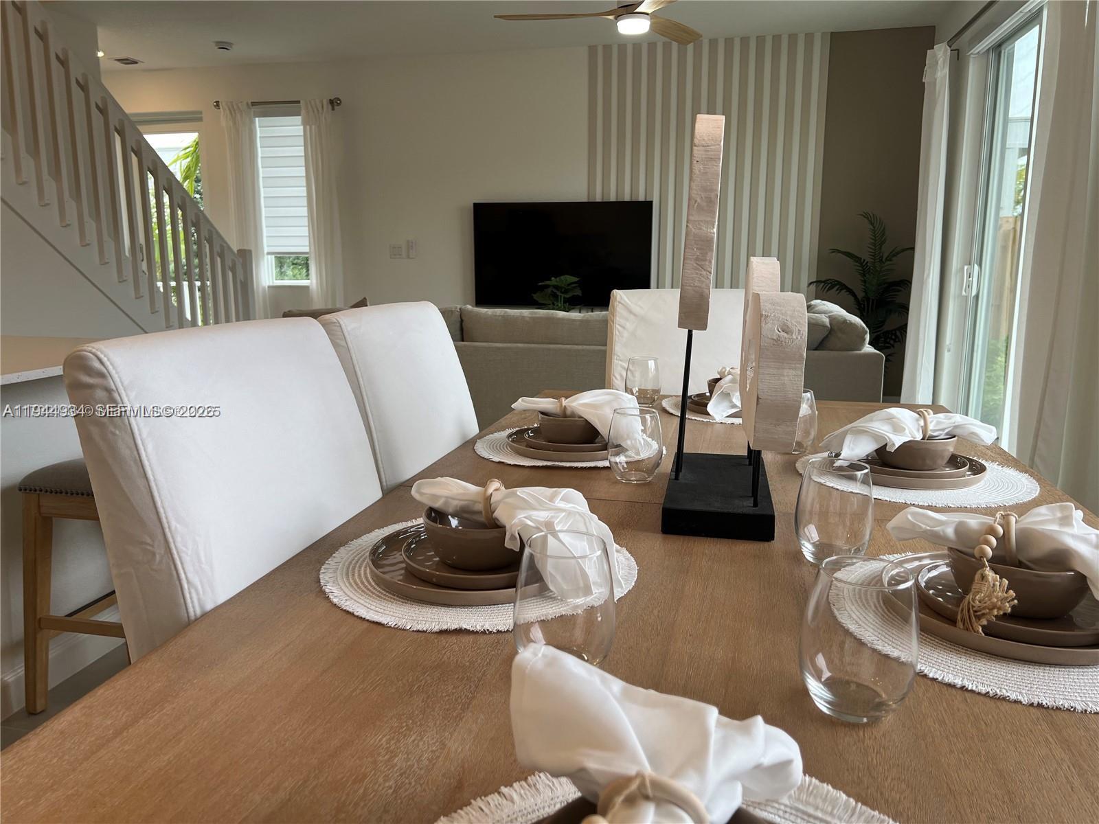 655 Southeast 13th Street Homestead, FL 33034 - Photo 14 of 38 a living room with furniture and a flat screen tv