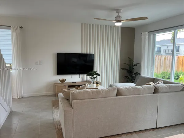 a living room with furniture and a flat screen tv