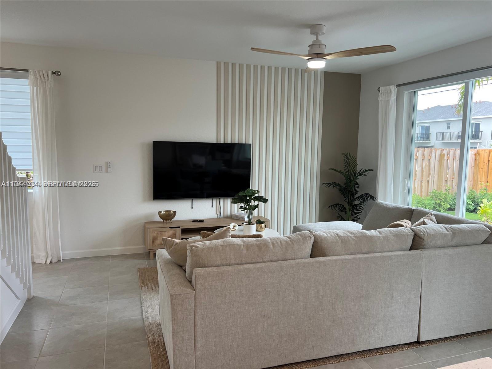 655 Southeast 13th Street Homestead, FL 33034 - Photo 15 of 38 a living room with furniture and a flat screen tv