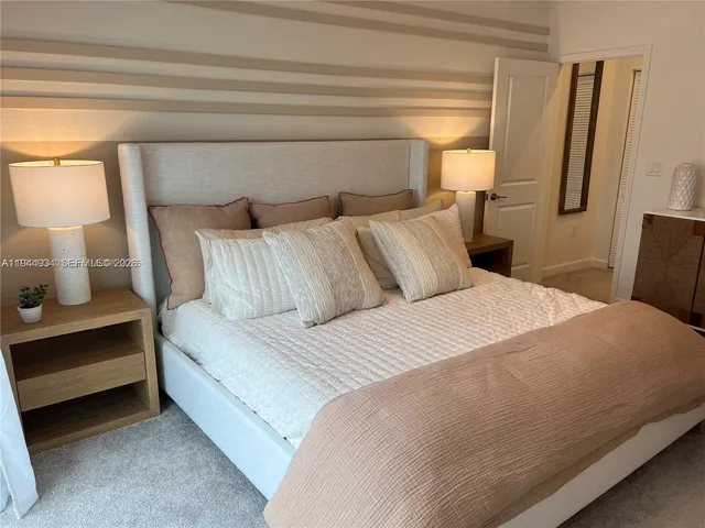 a bedroom with a bed and cabinets