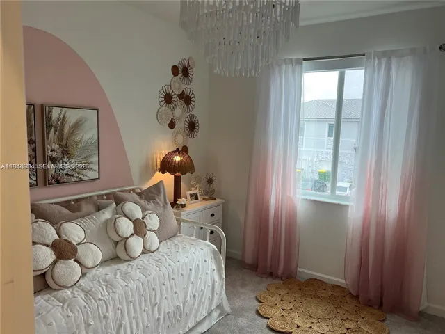 a bedroom with a bed and dresser with mirror