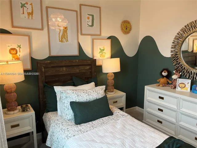 a bedroom with a bed and a mirror on the dresser