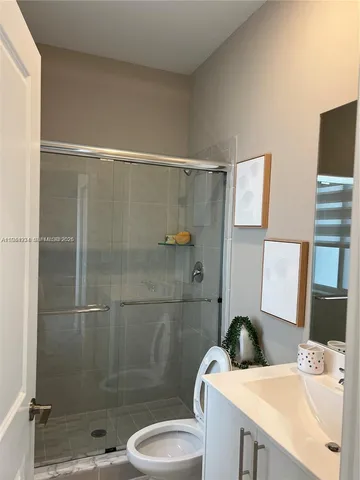 a bedroom with a bed a window and potted plant