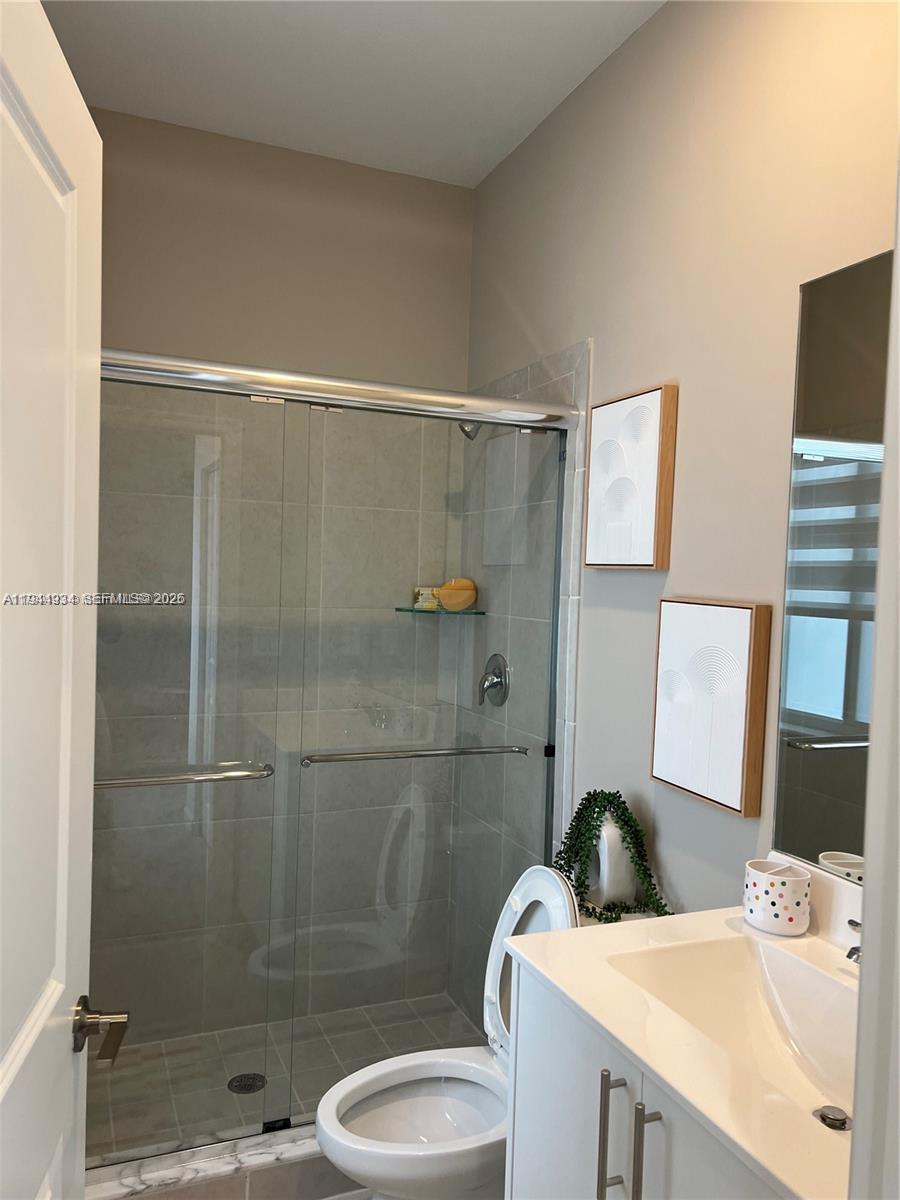 655 Southeast 13th Street Homestead, FL 33034 - Photo 30 of 38 a bathroom with a sink a toilet and shower