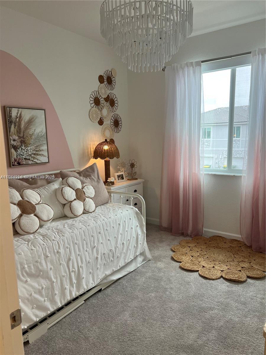 655 Southeast 13th Street Homestead, FL 33034 - Photo 32 of 38 a bedroom with a bed and a window