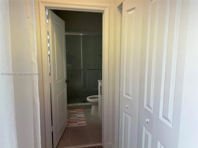 a view of a hallway with a room and a livingroom