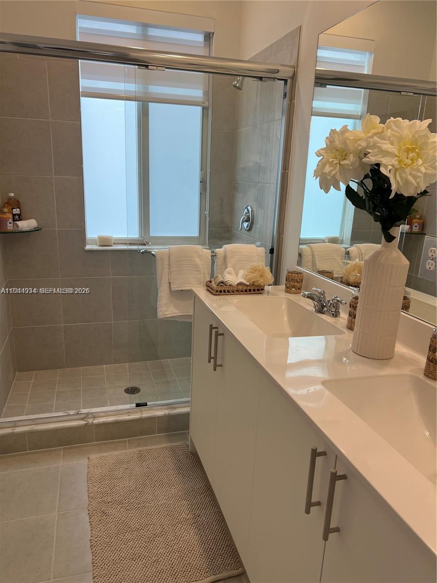 655 Southeast 13th Street Homestead, FL 33034 - Photo 36 of 38 a bathroom with a sink and a mirror