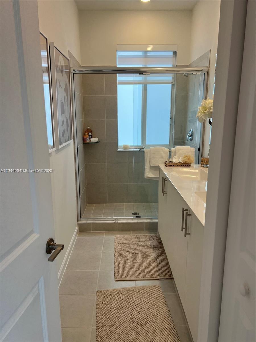 655 Southeast 13th Street Homestead, FL 33034 - Photo 37 of 38 a bathroom with a sink a toilet a mirror and shower