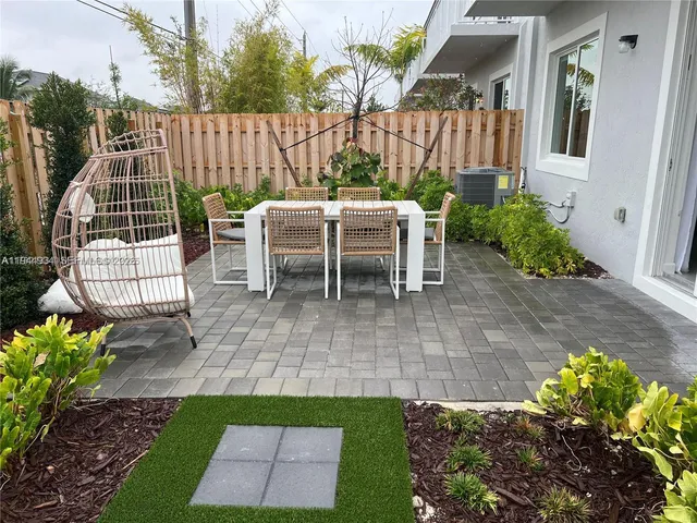 a view of a patio with a table and chairs