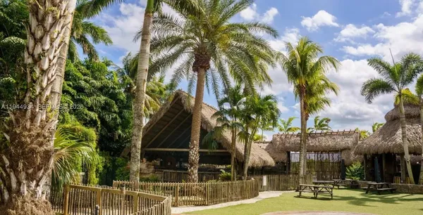 a view of a park with slide and potted plants