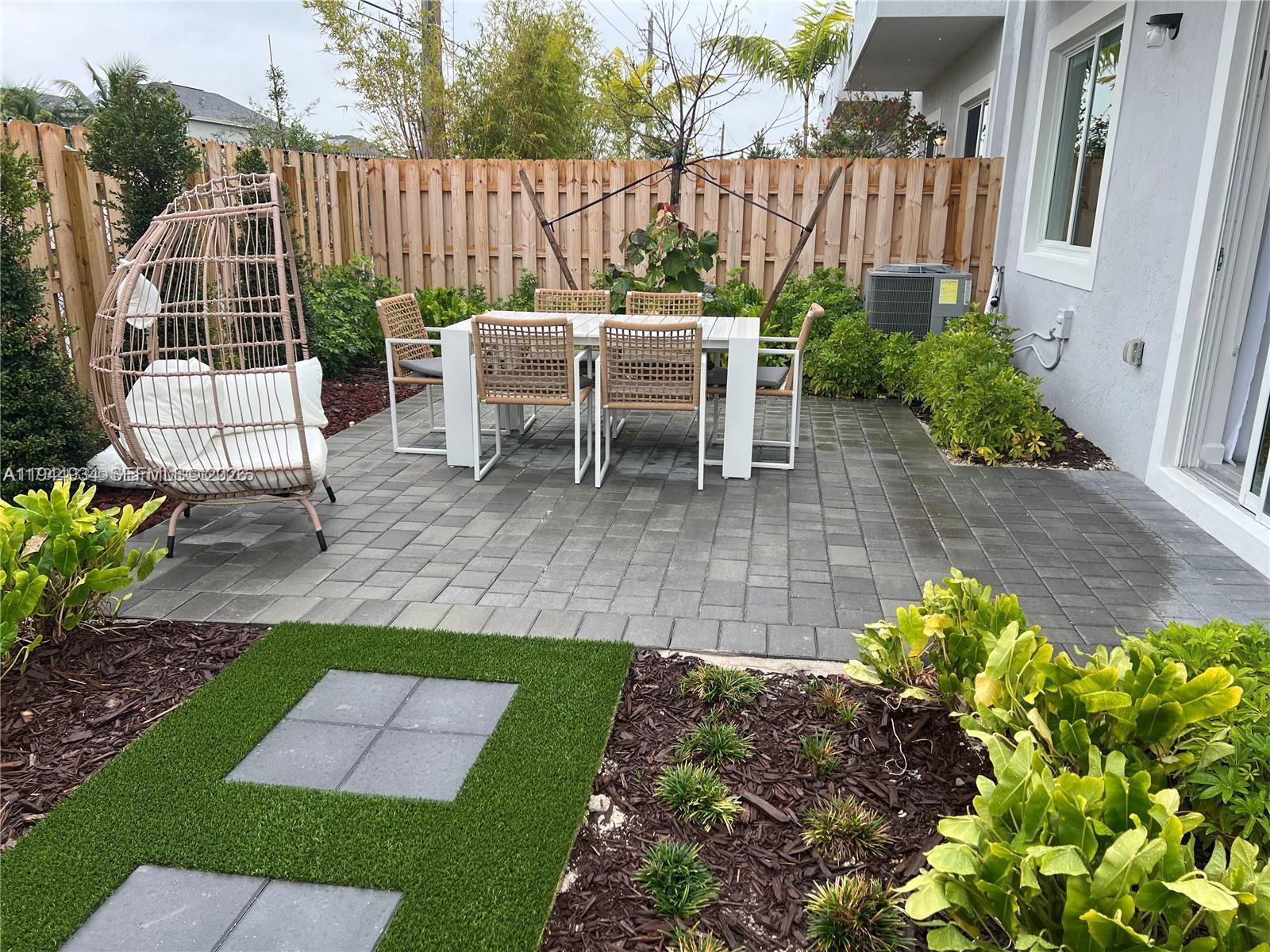655 Southeast 13th Street Homestead, FL 33034 - Photo 5 of 38 a view of a chair and table in backyard of the house