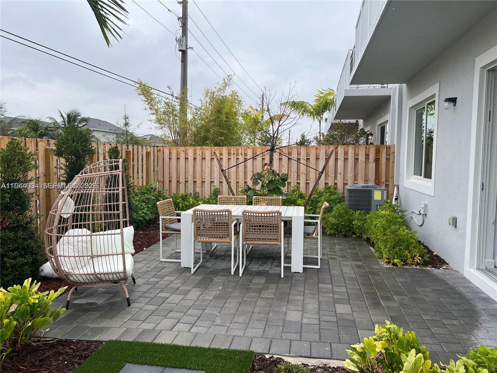 655 Southeast 13th Street Homestead, FL 33034 - Photo 6 of 38 a view of a chairs and table in backyard