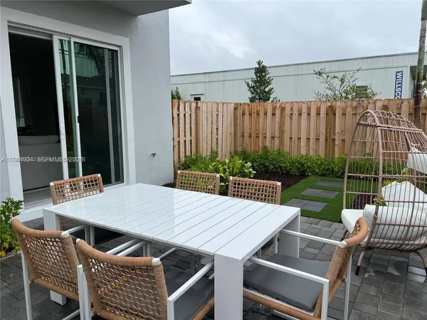 a view of a patio with a yard table and chairs