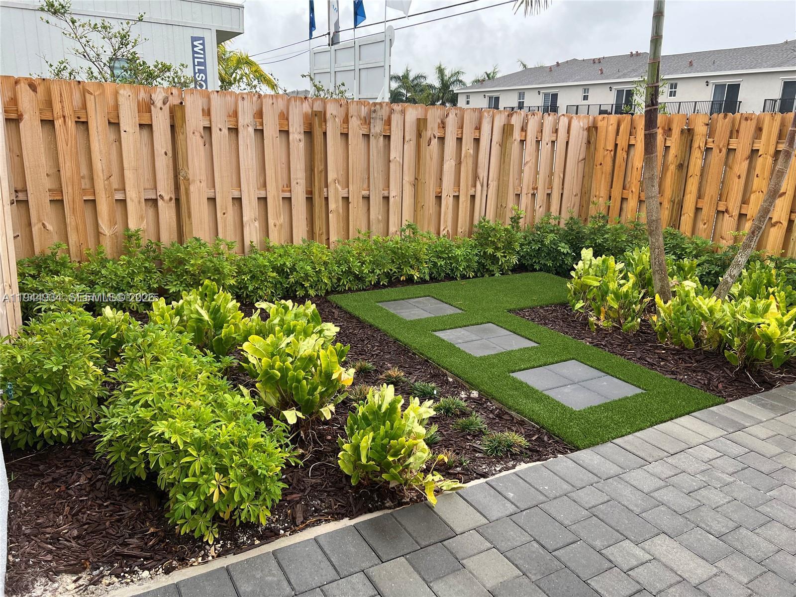 655 Southeast 13th Street Homestead, FL 33034 - Photo 8 of 38 a view of a garden with a chair