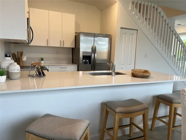 a kitchen with a table and chairs in it