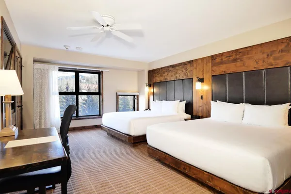 a bedroom with a large bed and a large window
