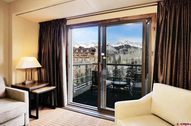 a living room filled with furniture and a window