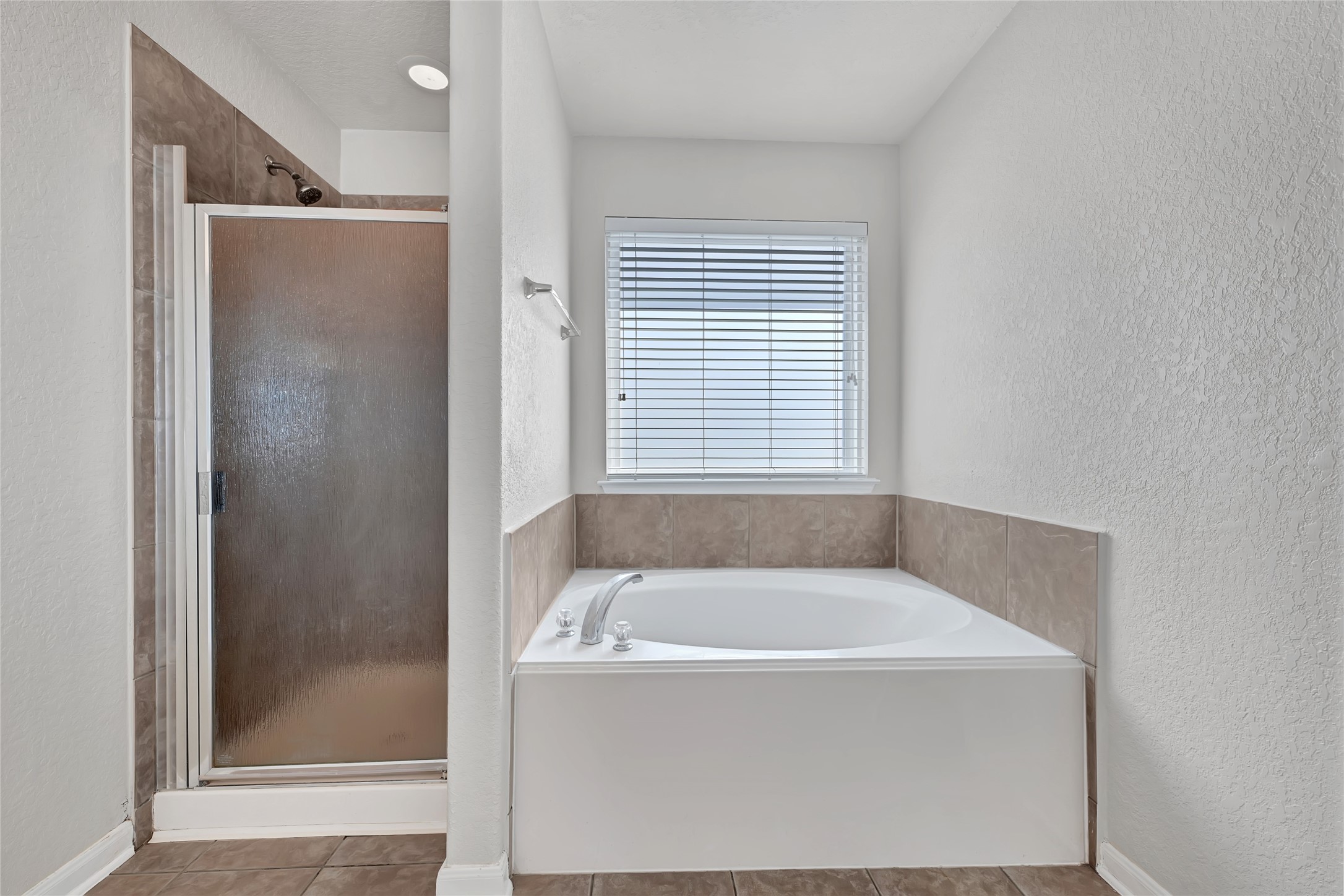 3114 Rendezvous Court Spring, TX 77373 - Photo 19 of 24 a white bath tub sitting in a bathroom