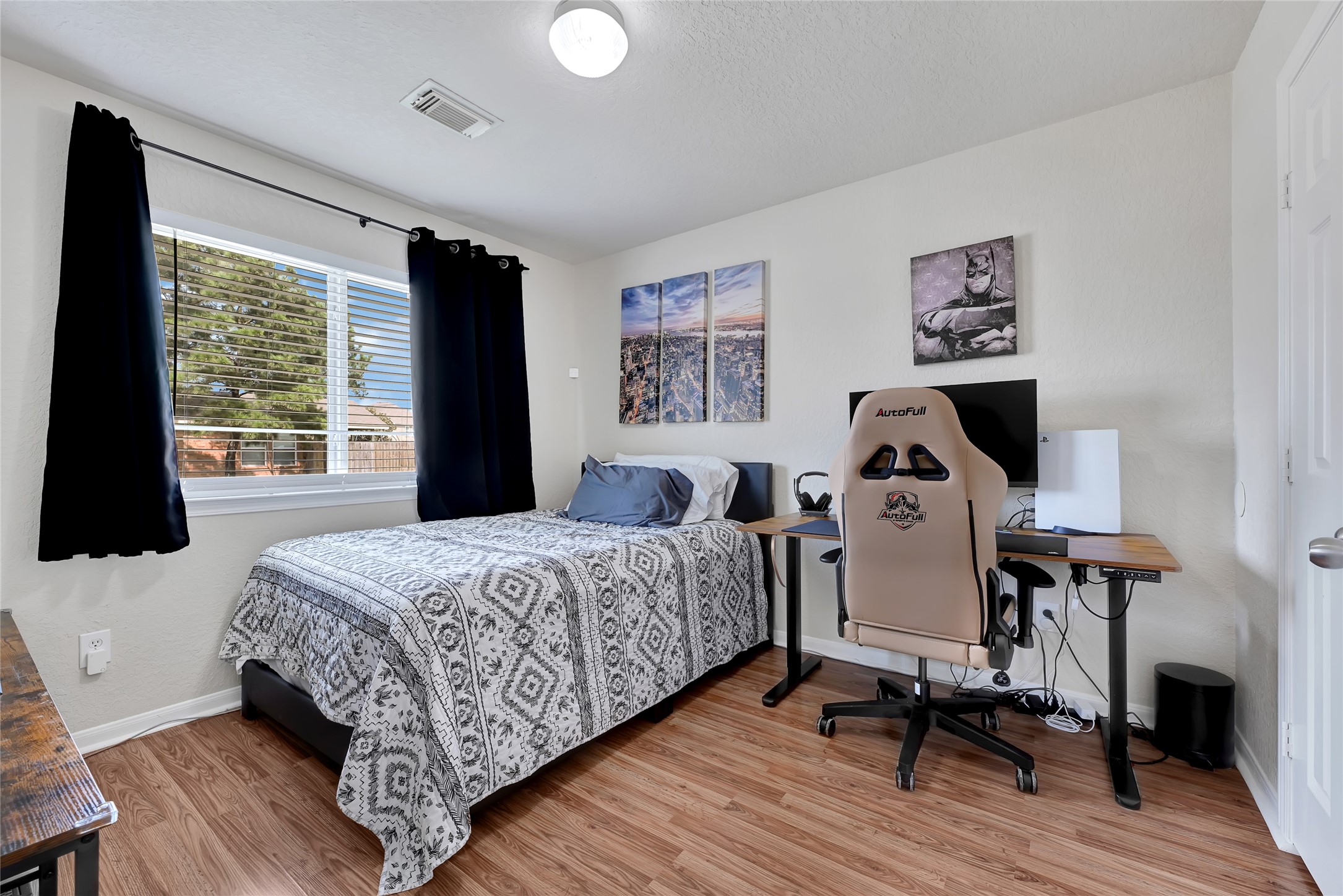 3114 Rendezvous Court Spring, TX 77373 - Photo 6 of 24 a bedroom with a bed a large window and wooden floor