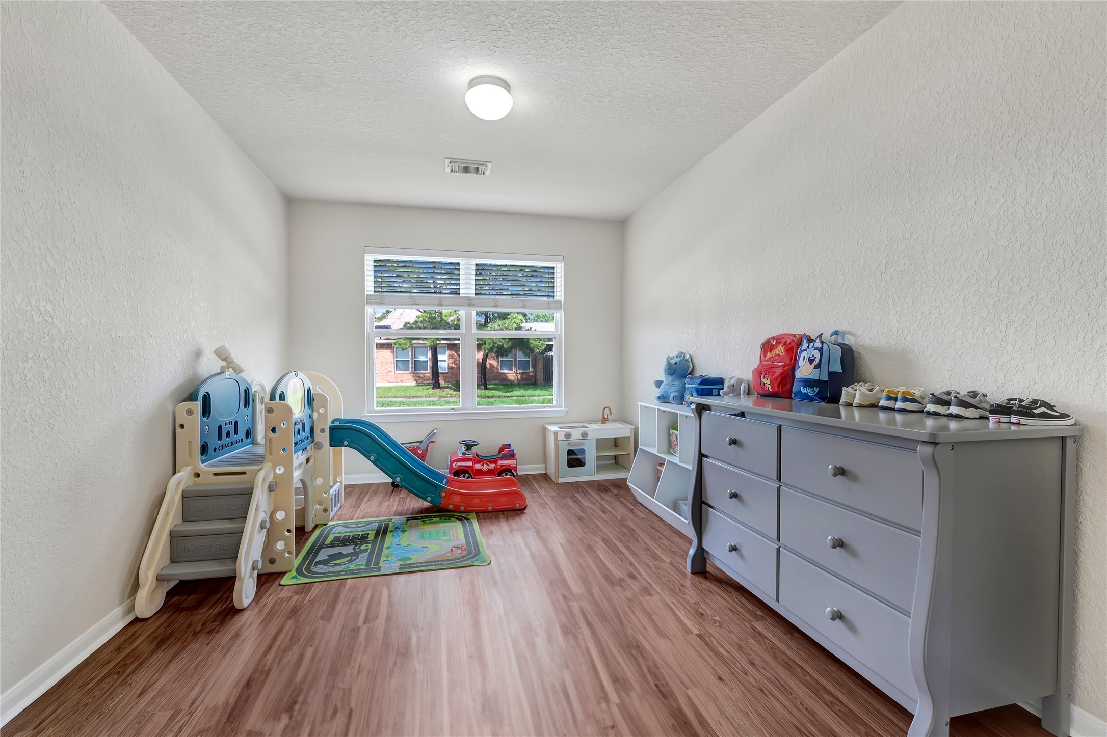 3114 Rendezvous Court Spring, TX 77373 - Photo 7 of 24 a bedroom with furniture and a wooden floor