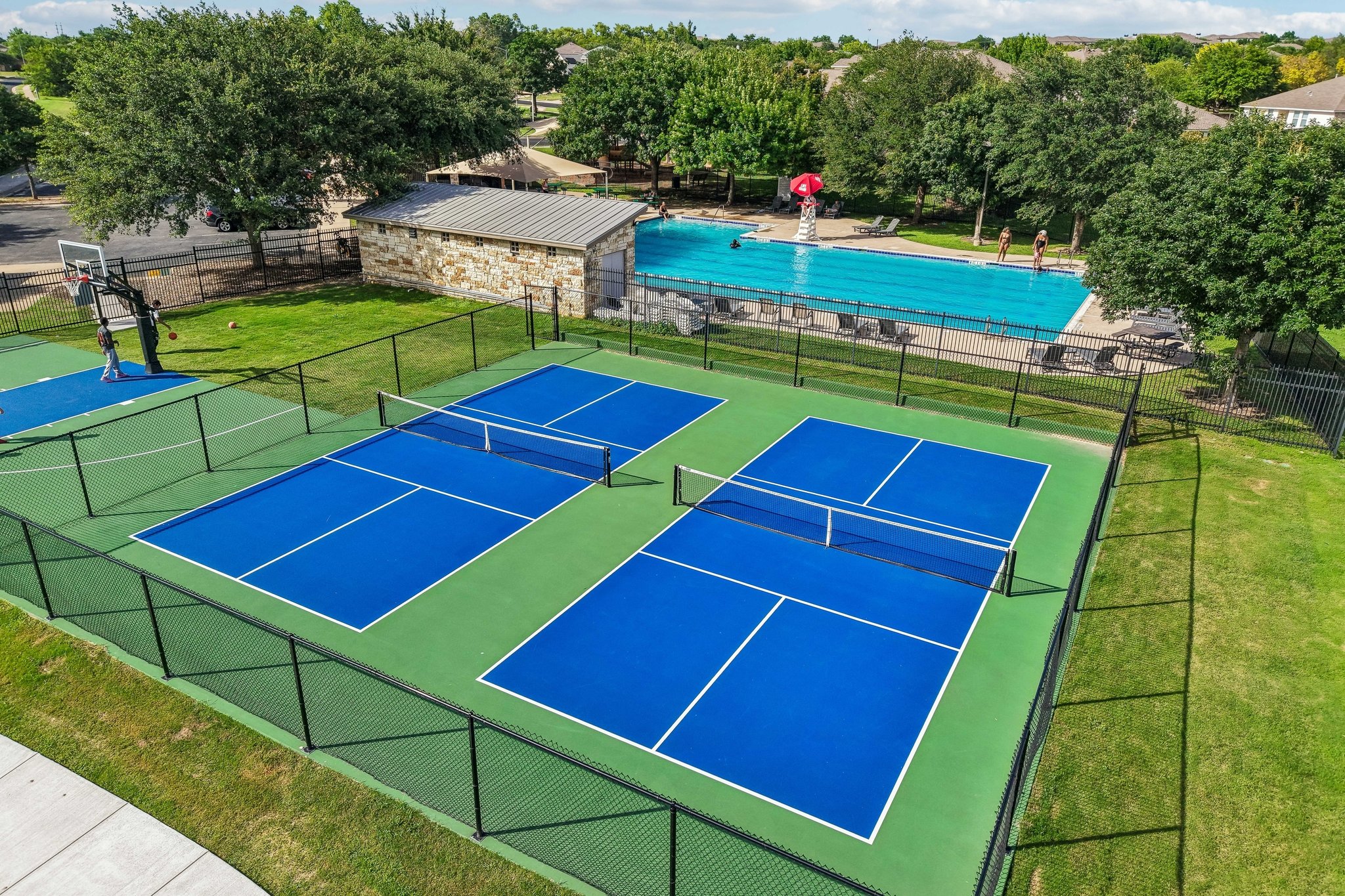 1721 Long Rifle Drive Austin, TX 78754 - Photo 35 of 38 Sporting enthusiasts will adore the vibrant pickleball courts and refreshing community pool, perfectly framed by lush landscaping.
