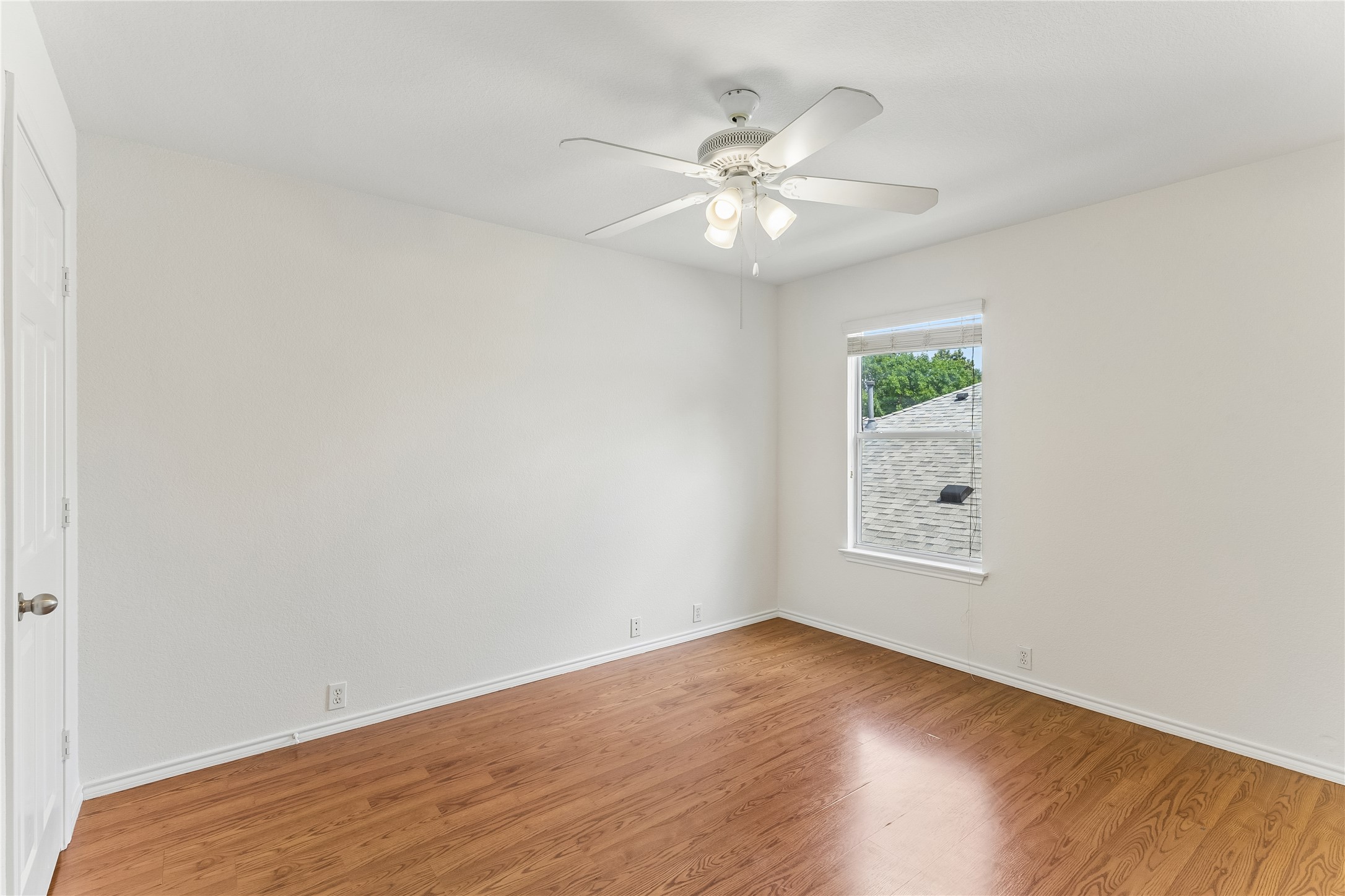 2372 Paradise Ridge Drive Round Rock, TX 78665 - Photo 31 of 40 A well-lit bedroom with rich wood flooring and a modern ceiling fan for comfort.