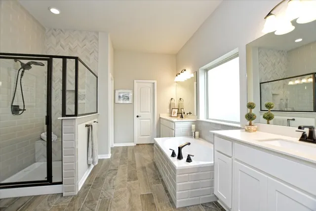 a en suite bathroom with a double vanity sink and a large mirror