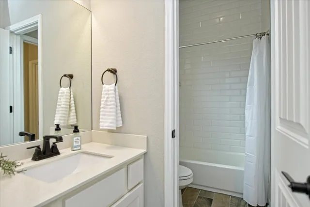 a bathroom with a toilet a sink and a mirror