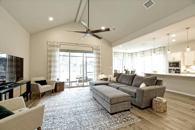 a kitchen with stainless steel appliances a sink a stove a refrigerator cabinets and a center island