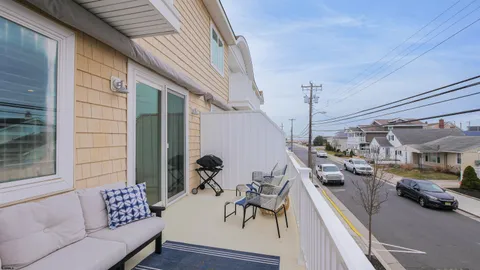 a view of a patio with couches and potted plants