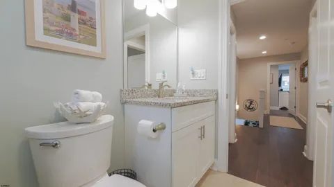 a bathroom with a sink vanity granite and a mirror