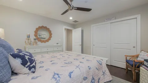 a bedroom with a large bed and a chandelier