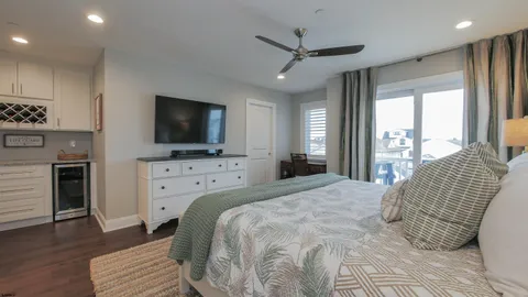 a bedroom with a bed tv and a window