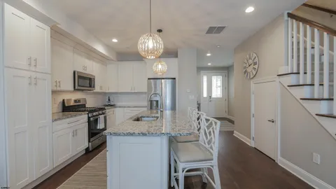 a large kitchen with a table and chairs