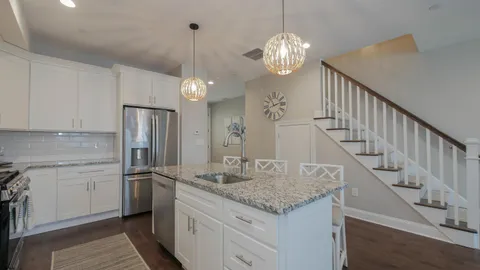 a kitchen with sink cabinets and refrigerator